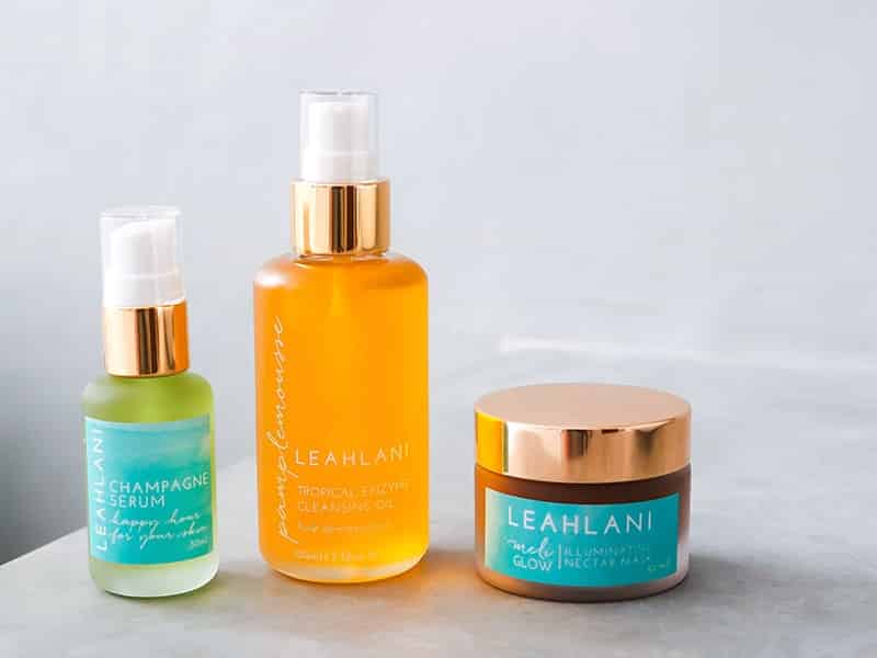 Leahlani Skincare review featuring Pamplemousse Tropical Enzyme Cleansing Oil, Happy Hour Serum (Champagne Serum), and Meli Glow Illuminating Nectar Mask.