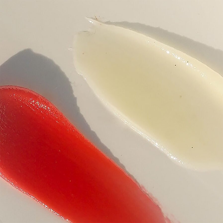 Swatches of MARA Beauty Sea Silk Lip Balms in shades clear and soft coral