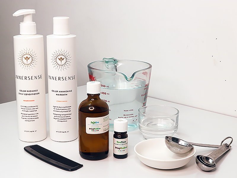 Natural scalp treatment using tea tree essential oil, jojoba oil, vinegar hair rinse, and mild shampoo from Innersense